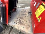 a red machine that is sitting on the side of the road