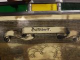 a close up of a picture of a clock with a banner on it