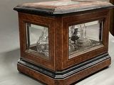 a glass case with a clock inside of it on a table