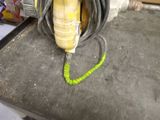 a picture of a yellow and black corded drill on a table