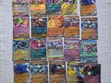 a close up of a pile of pokemon cards on a table