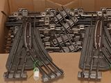 a lot of train tracks in a box on the floor