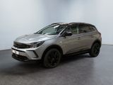 a silver suv parked in a room with a black floor