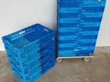 two blue plastic crates sitting next to each other on a concrete floor