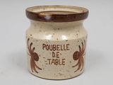 a brown and white jar with writing on it