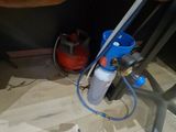 a blue hose attached to a metal pipe on the floor