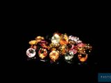 several different colored gems are arranged on a black surface