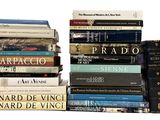 many books stacked on top of each other on a table