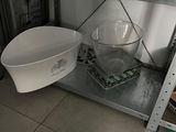 a metal shelf with a bowl and a bowl on it