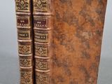 deux vieux livres posés l'un sur l'autre sur une table