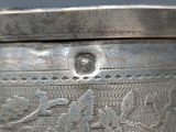 a close up of a silver container on a table