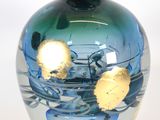 a glass vase with a blue and green design on it