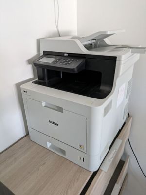 a printer that is sitting on top of a wooden table