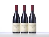 three bottles of wine sitting on top of a table