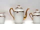 three pieces of porcelain tea and coffee set with gold trimming