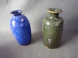 two vases sitting next to each other on a table