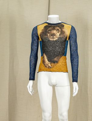 a mannequin with a lion on it in front of a curtain