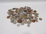 a pile of coins sitting on a white surface