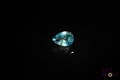 a blue diamond on a black surface