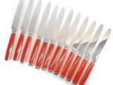 a lot of forks and knives on a white surface