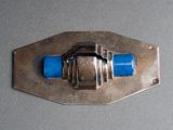 a metal buckle with a blue handle on a gray surface