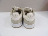 beige and white adidas sneakers with white soles on a white surface