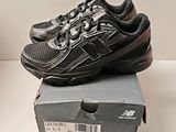 a box with a pair of new balance shoes on top of it
