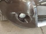 a close up of a car ' s front bumper with a hole in it