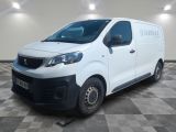 the white van is parked in a large room with a checkered floor