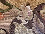 a picture of a close up of a bed with a floral design on it