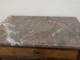 a marble top table with a drawer underneath it