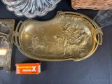 a gold tray with a picture on it next to other items