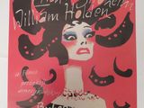 une image représentant une affiche sur laquelle figure une femme en robe noire sur fond rouge