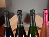 three bottles of wine are lined up in a row on a table