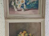 two paintings of flowers and fruit on a table in front of a white wall