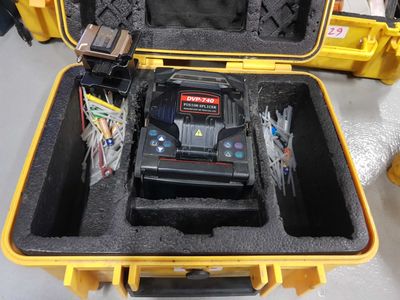 a yellow case with a tool in it on a table