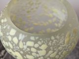 a glass vase that is sitting on top of a table