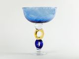 a blue glass with a gold ring on it