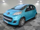 the small blue car is parked on a checkered floor