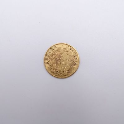 a close up of a gold coin on a white surface
