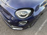 a blue car that is parked in a parking lot