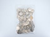 a bag full of silver coins on a white surface