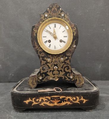 a clock that is sitting on a box on a table