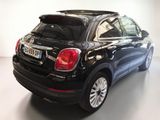 the back end of a black fiat suv parked in a white room