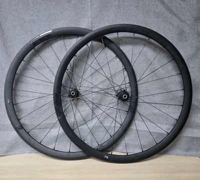 pair of black bicycle wheels sitting on a wooden surface