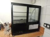 an image of a glass door refrigerator in a kitchen