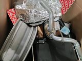many pieces of luggage in a box on the floor