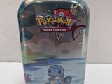 pokemon trading card tin with a small figure in it