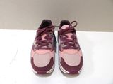 purple and pink running shoes with laces on a white surface