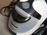 a vacuum that is sitting on the floor next to a laptop